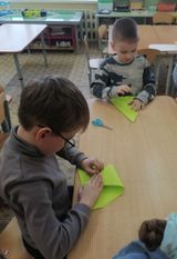 дети складывают самолет техникой оригами